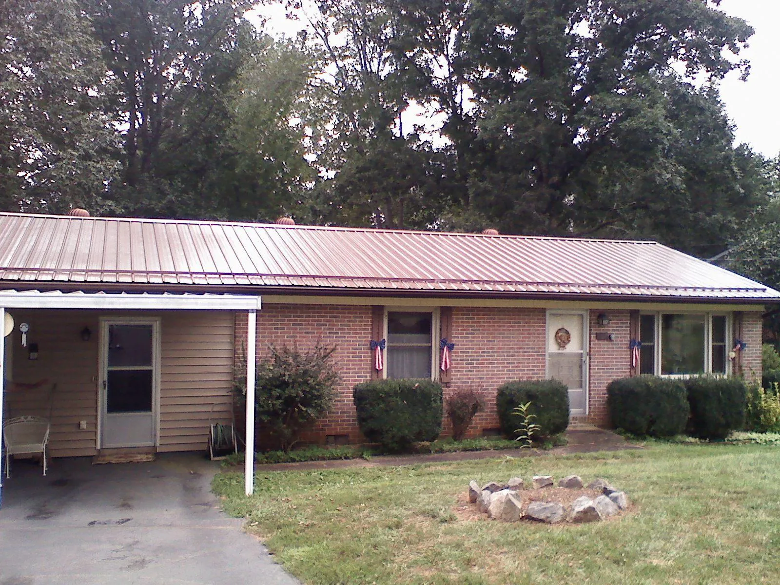 Bronze metal roof and carport on a brick ranch home — Roof Repair work by our crew in Seaside Park